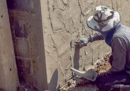 Stucco contractor applying brown coat to exterior wall of home in Reno, NV.